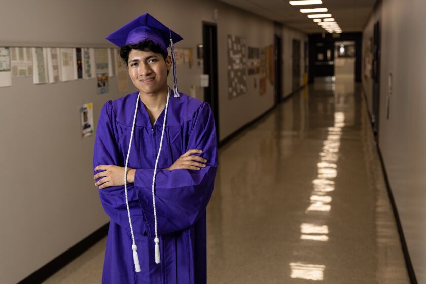 Alejandro Pliego, 18, poses in a hallway at Rock Academy in Liberty Station on Friday, May 5, 2023. Pliego, the first in his family to go to college, will be attending Princeton with a full-ride scholarship. He hopes to study public policy and minor in global health.