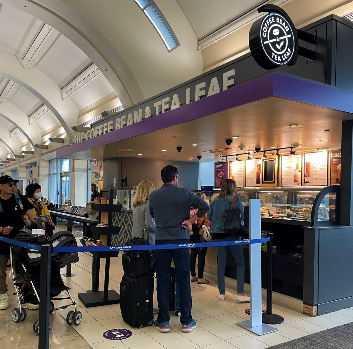 Travelers at John Wayne Airport line up at a Coffee Bean & Tea Leaf in the terminal. 