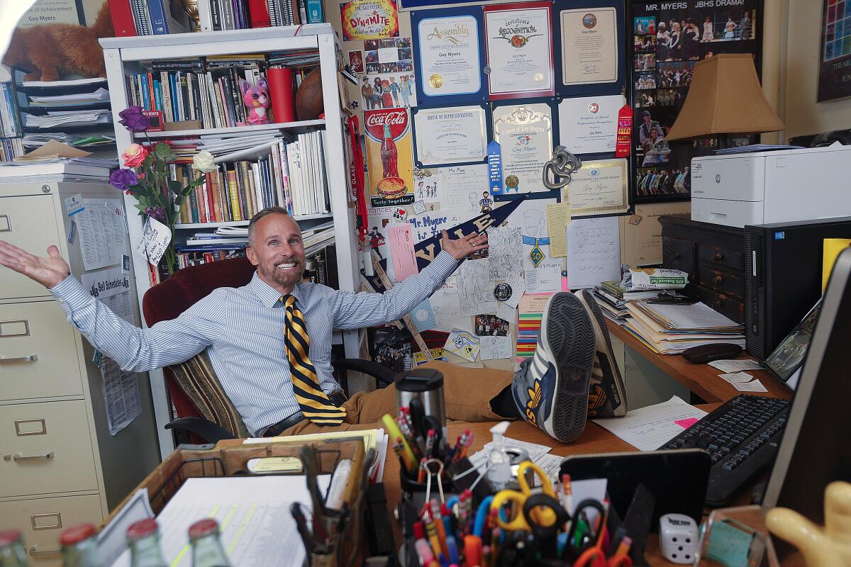 Burroughs High School drama teacher Guy Myers reclines in his classroom desk space on Monday. He was named one of five California Teachers of the Year on Friday. The California Teacher of the Year representative was chosen by Tony Thurmond, state superintendent of public instruction.