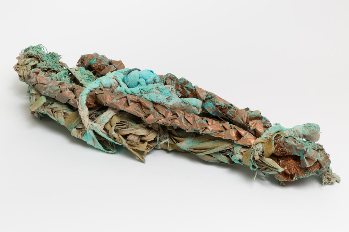 An artwork made of palm fronds, crepe rubber band, linen, copper, copper powder and clear gesso.