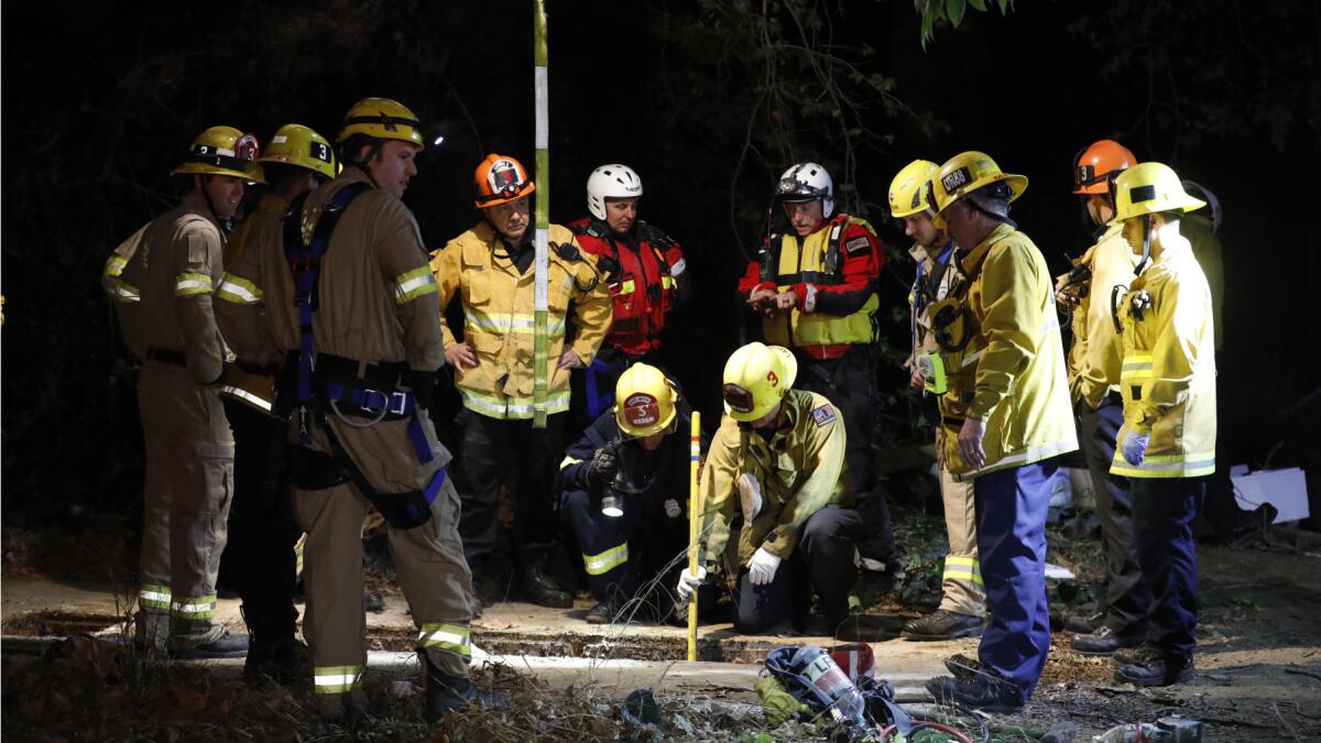 Firefighters search for a 13-year-old boy who fell through a drainage pipe near the L.A. River at the 134 and 5 Freeway interchange.
