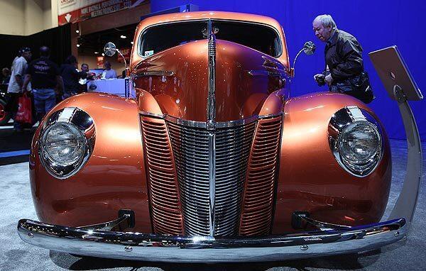 A man looks inside the 1940 "Catch Me If You Can!" Ford coupe.