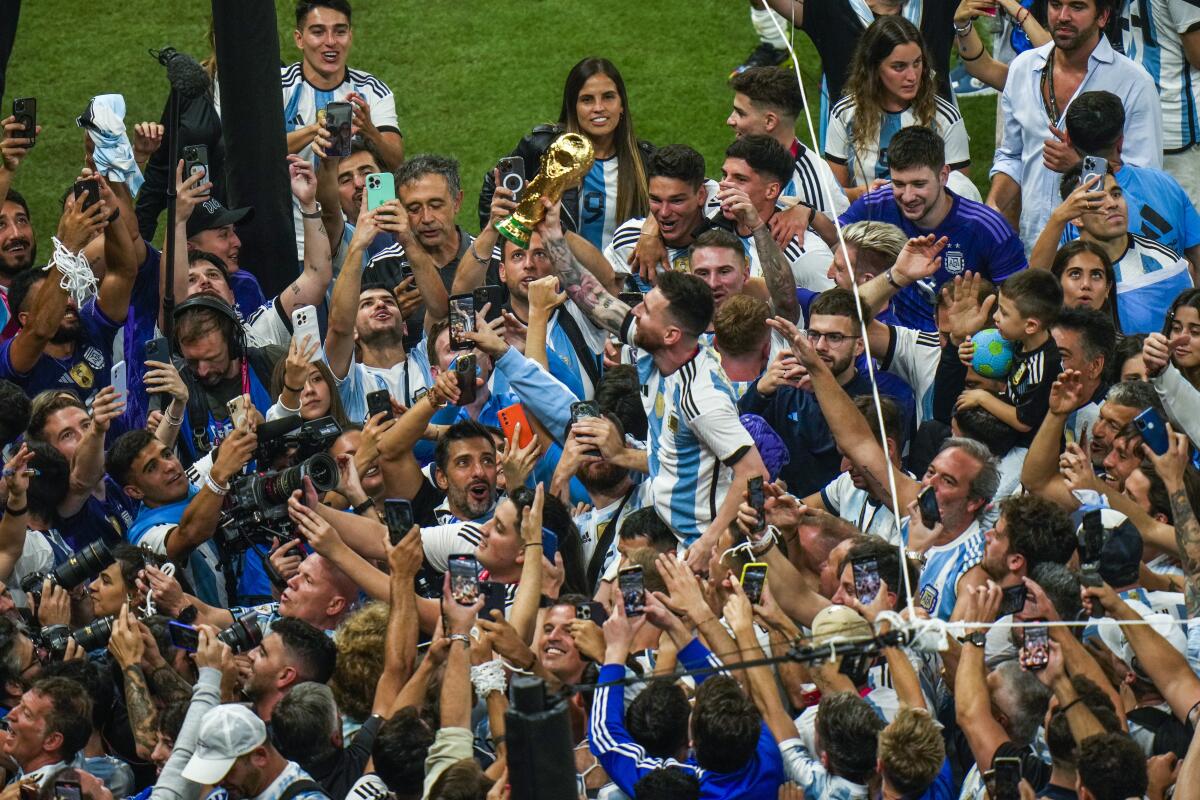 Lionel Messi celebrates with the World Cup trophy following Argentina's victory over France.