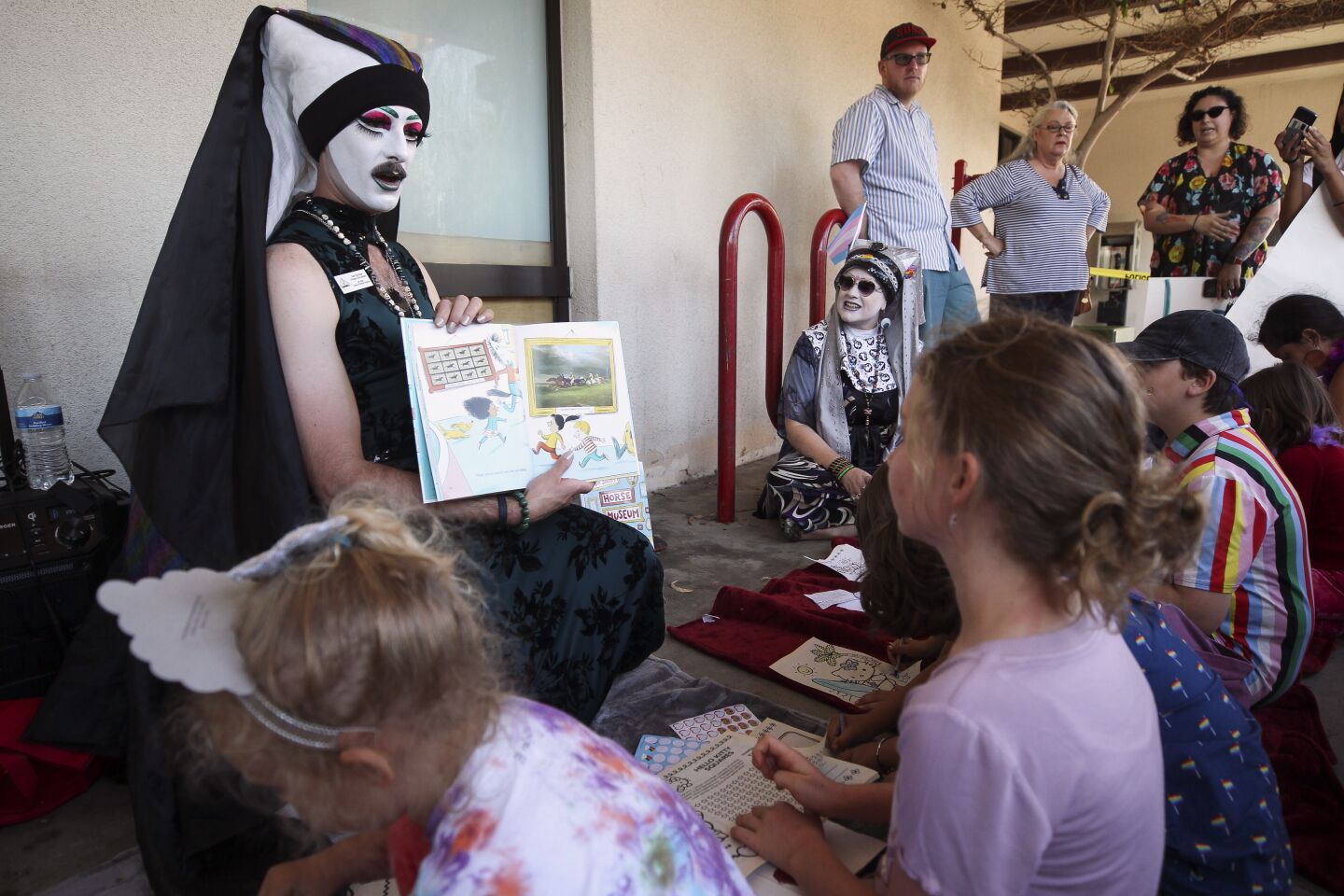 Sister Rita Booke, with the San Diego Sisters of Perpetual Indulgence, reads a book to children outside of the Chula Vista Public Library, Civic Center Branch, on Tuesday, September 10, 2019 in Chula Vista, California.