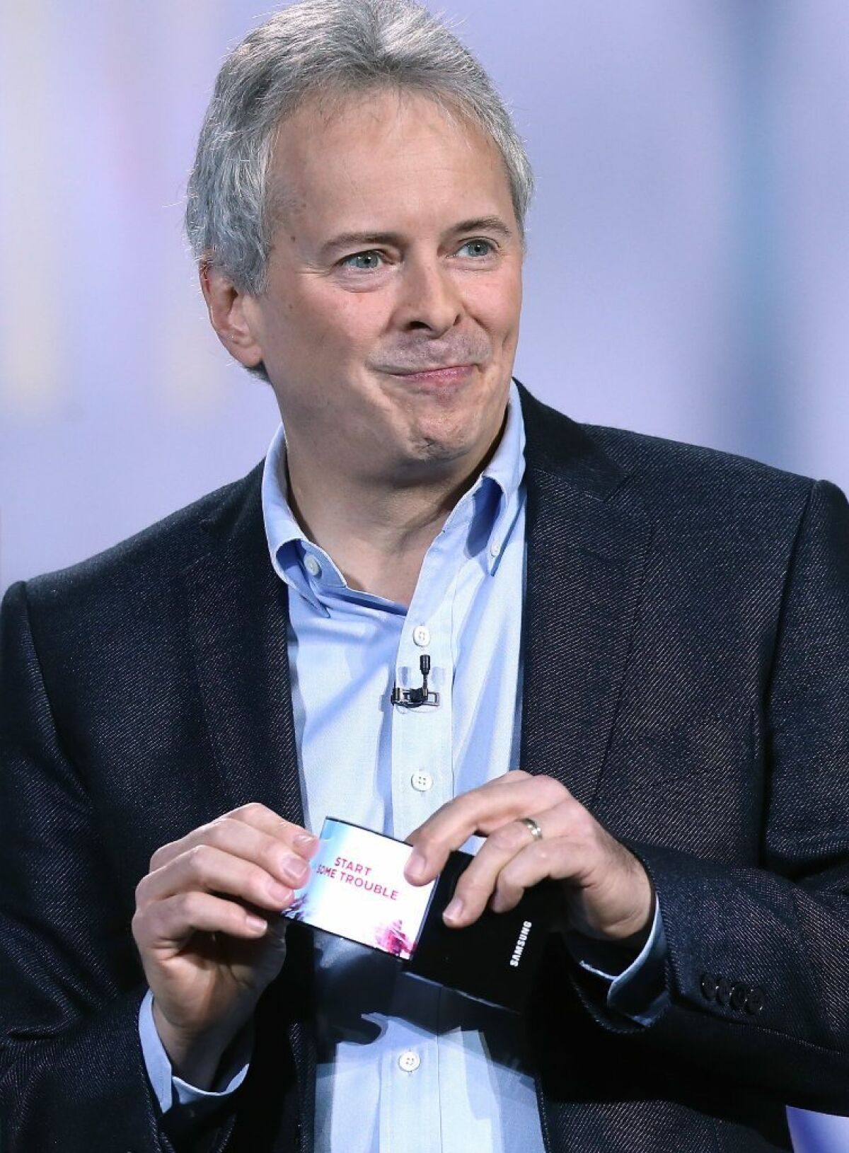 Brian Berkeley, senior vice president of Samsung's display lab, shows a prototype of the Youm flexible display at CES.