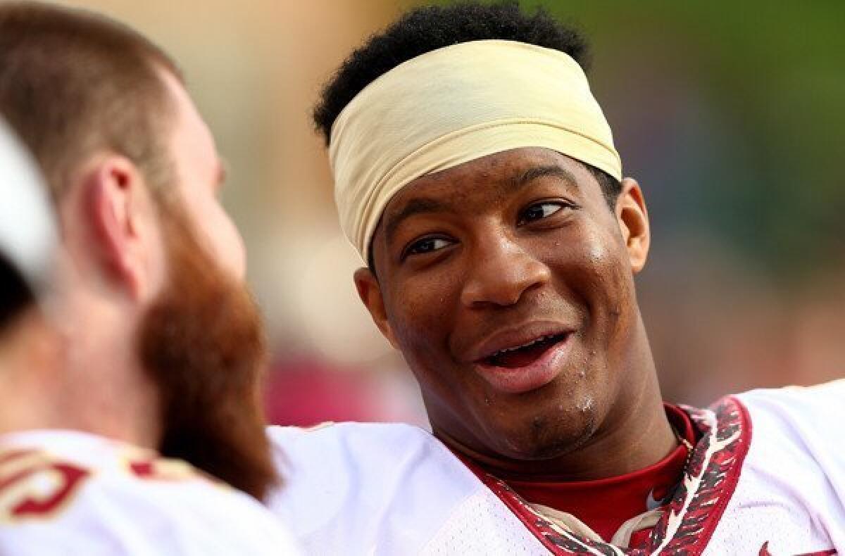 Quarterback Jameis Winston talks to Florida State teammate Bryan Stork during a victory over Wake Forest last month.