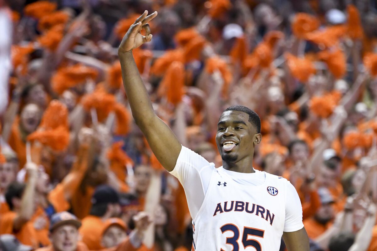 FILE - In this Feb. 12, 2020, file photo, Auburn guard Devan Cambridge celebrates a 3-point basket against Alabama during the second half of an NCAA college basketball game in Auburn, Ala. The top returning scorers for Auburn are sophomore Devan Cambridge (4.2 points) and Memphis transfer Jamal Johnson (3.5). (AP Photo/Julie Bennett, File)