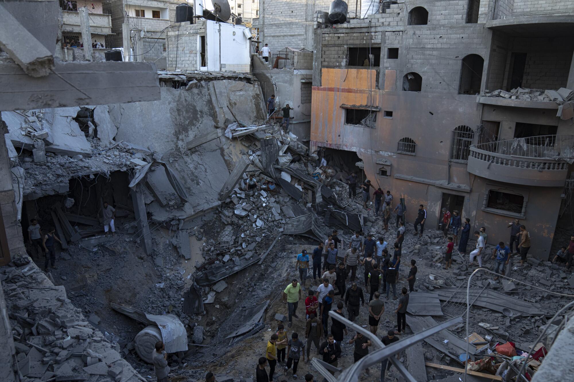 People searching for survivors in the rubble of a building destroyed by Israeli airstrike.