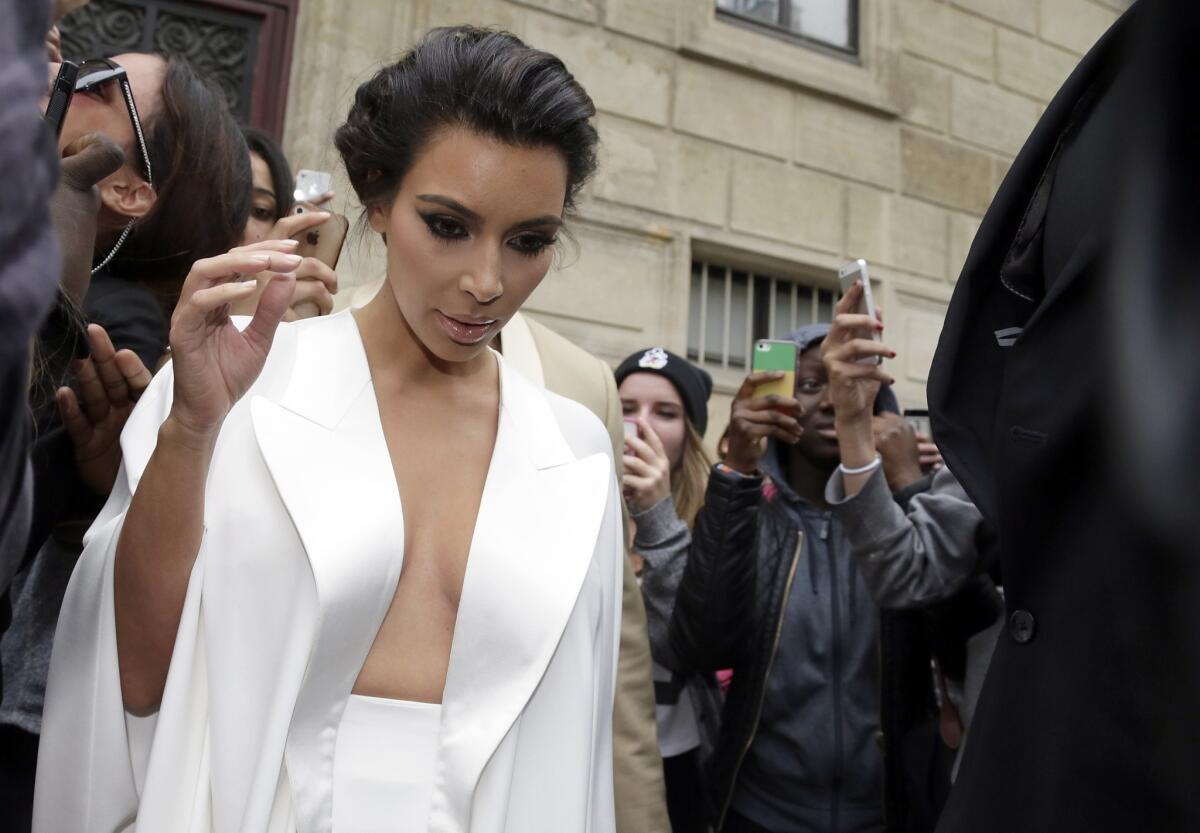 Kim Kardashian, shown in France just before her wedding to Kanye West, has called for an end to the Beverly Hills Hotel boycott because, she says on her blog, it has hurt the workers there.