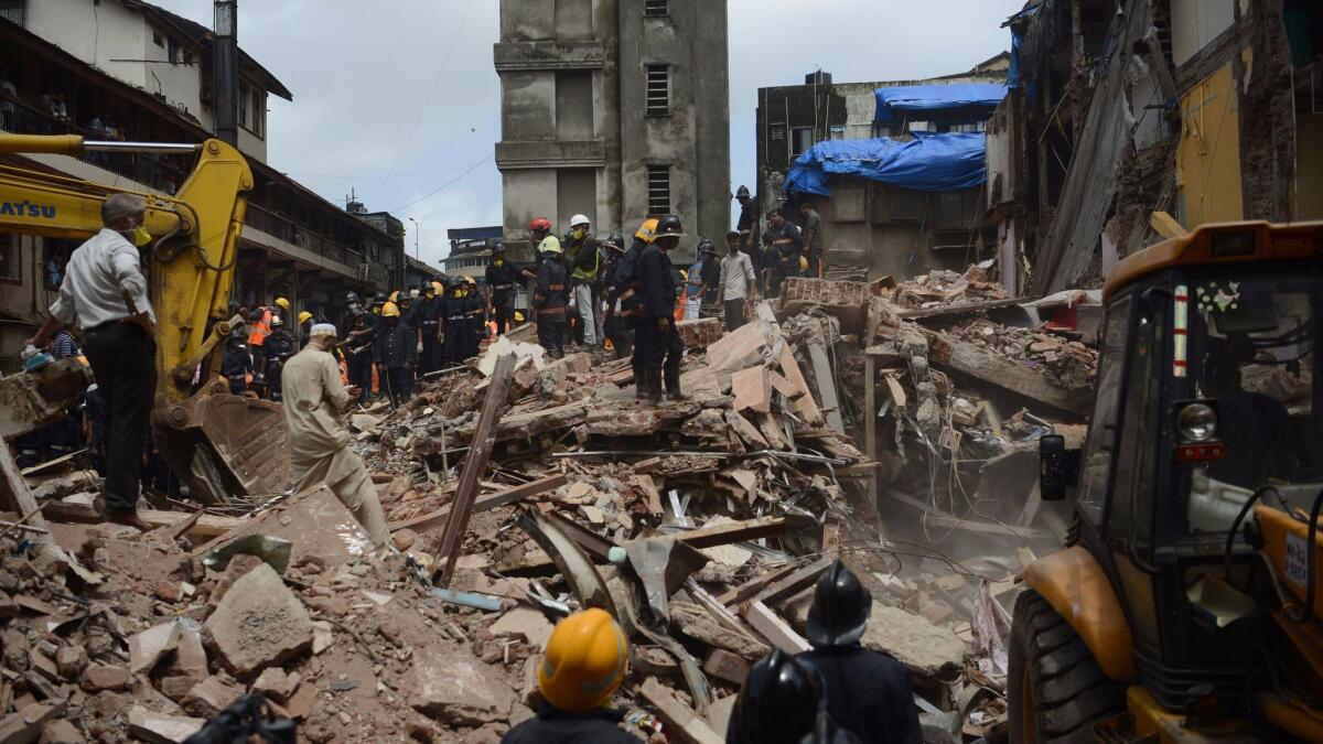 Rescue workers look for survivors in the debris of a collapsed building in Mumbai, India, on Aug. 31.