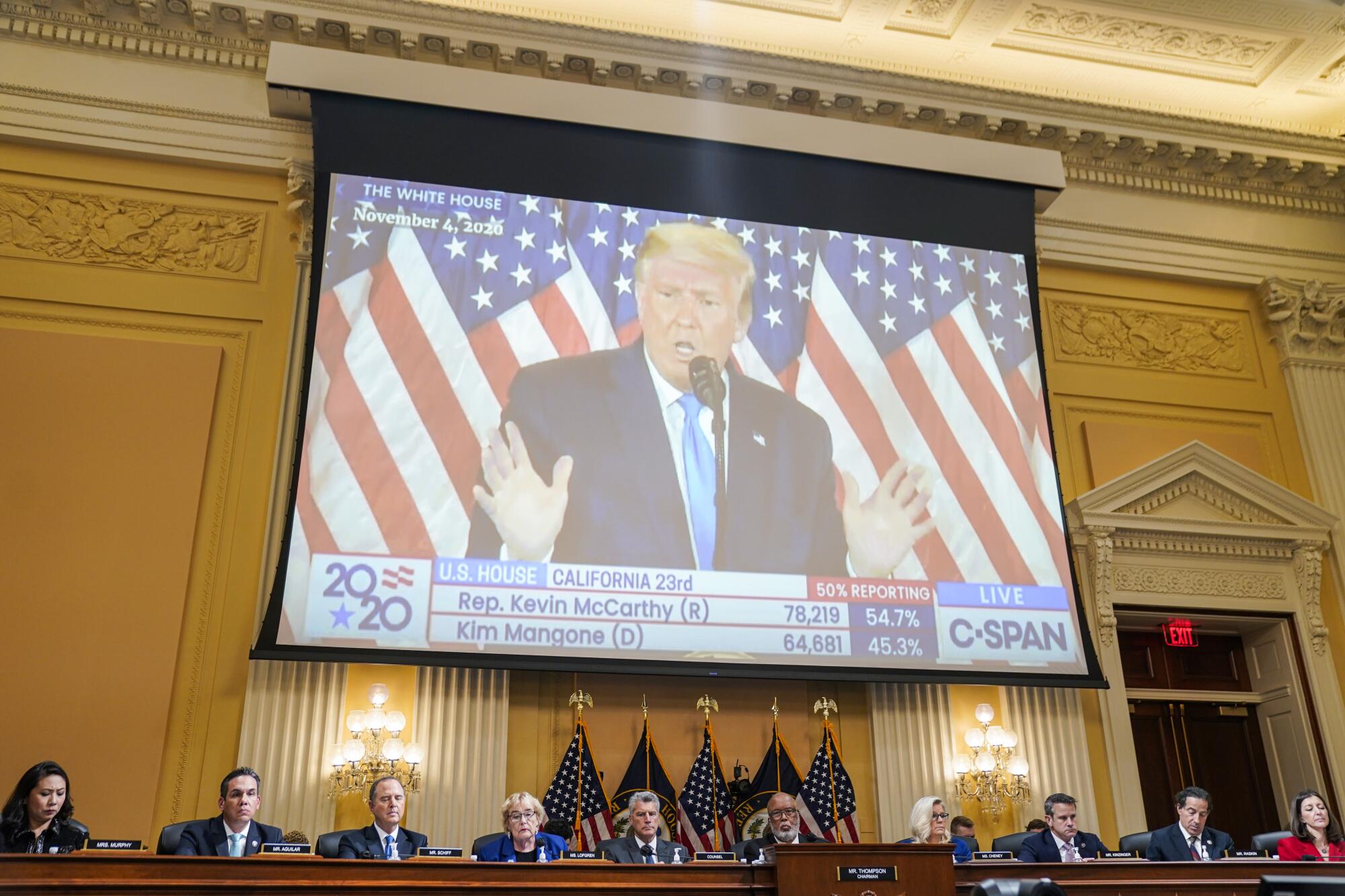 Former President Trump is projected on a monitor during a hearing of the House committee