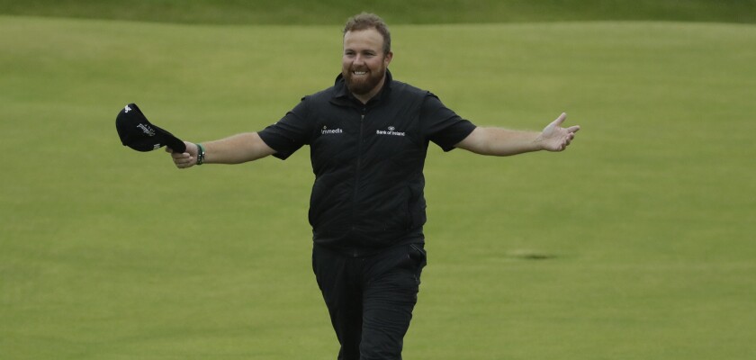 Ireland's Shane Lowry walks with his arms outstretched as he acknowledges the crowd on the 18th green during the final round of the British Open on Sunday.