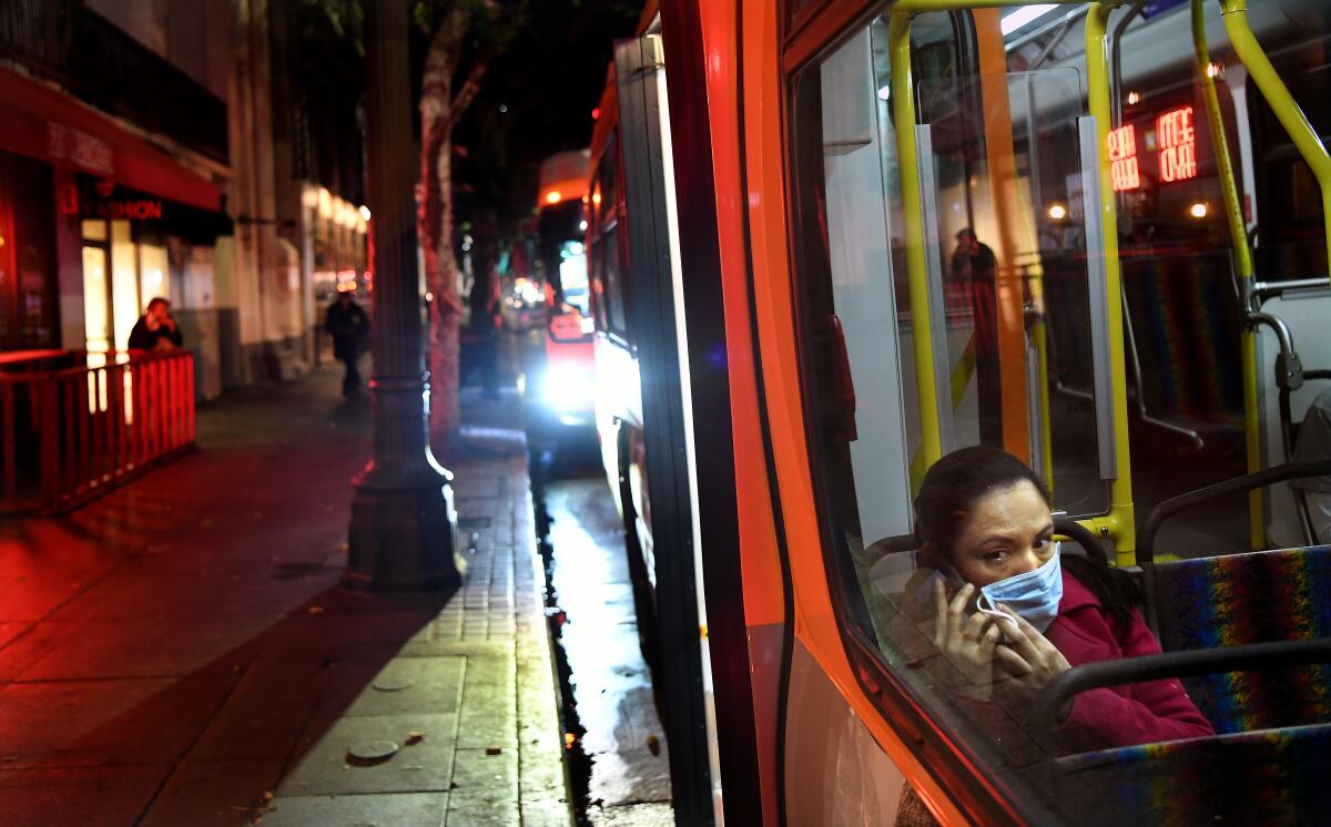 A passenger wears a mask on a Metro bus during the coronavirus outbreak in downtown Los Angeles.