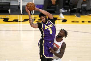LOS ANGELES, CA - MAY 11: Los Angeles Lakers forward Anthony Davis (3) is fouled by New York Knicks forward Julius Randle (30) on an inbound pass in the first period at the Staples Center on Tuesday, May 11, 2021 in Los Angeles, CA. (Gary Coronado / Los Angeles Times)