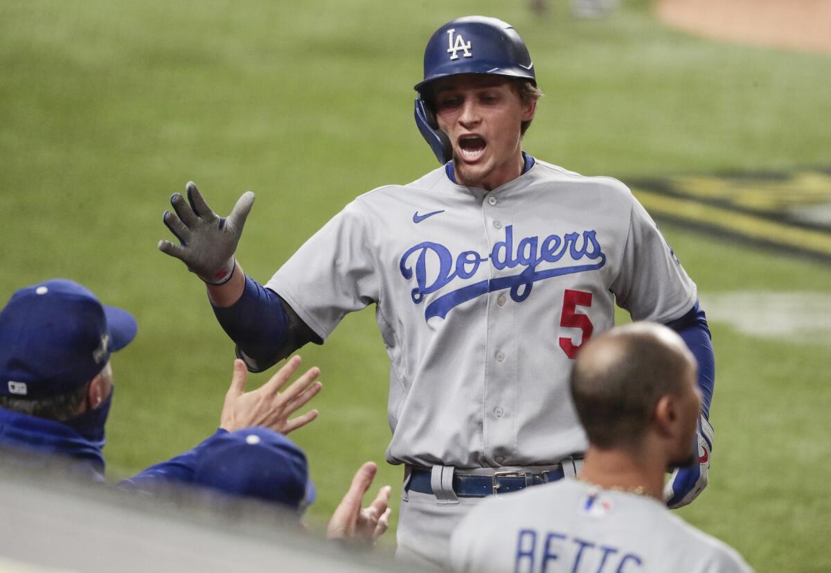 Dodgers shortstop Corey Seager is congratulated as he returns to the dugout after hitting a home run in the fourth inning.