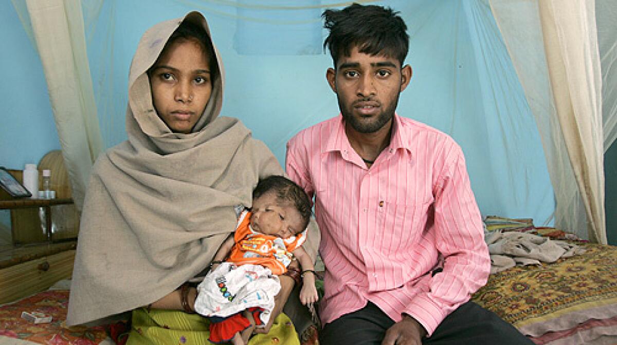 Parents Sushma, left, and Vinod Singh pose with their daughter Lali at their residence in Saini Sunpura, 50 kilometers (31 miles) east of New Delhi, India, Tuesday, April 8, 2008.