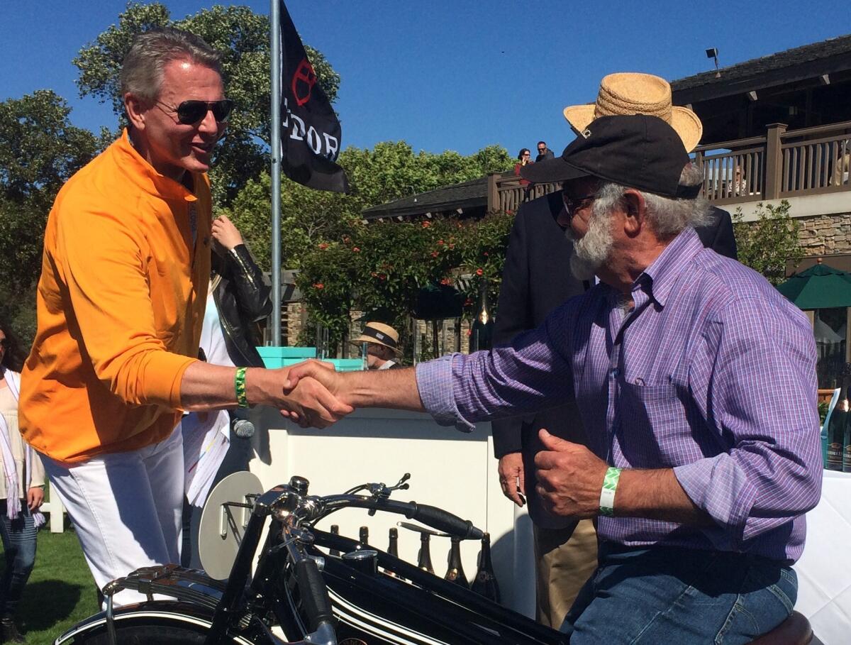Event founder Gordon McCall congratulates local collector Robb Talbott on his Best in Show award at the 8th annual Quail Motorcycle Gathering in Carmel Valley.