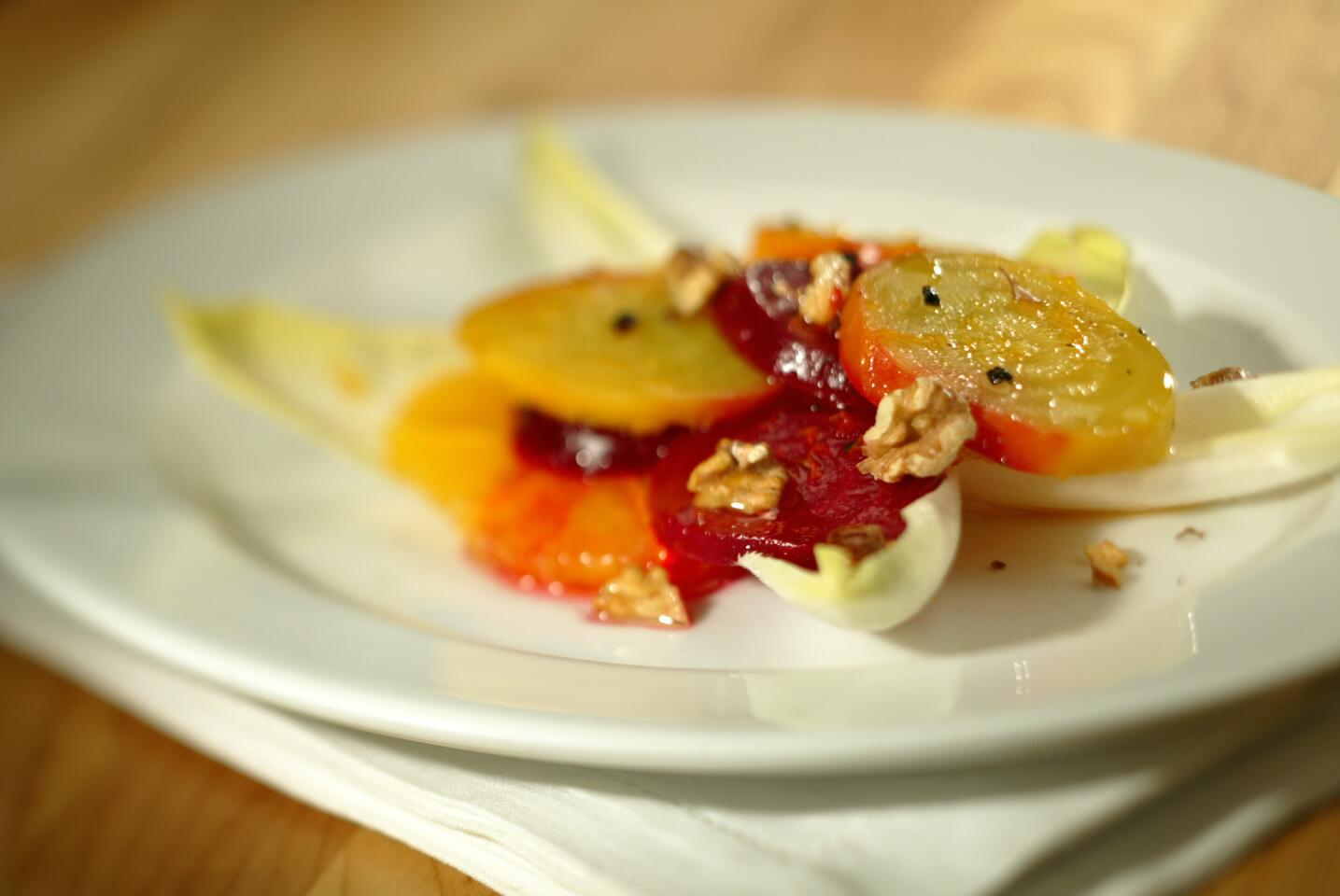 Red and golden beets with oranges, endive and walnuts