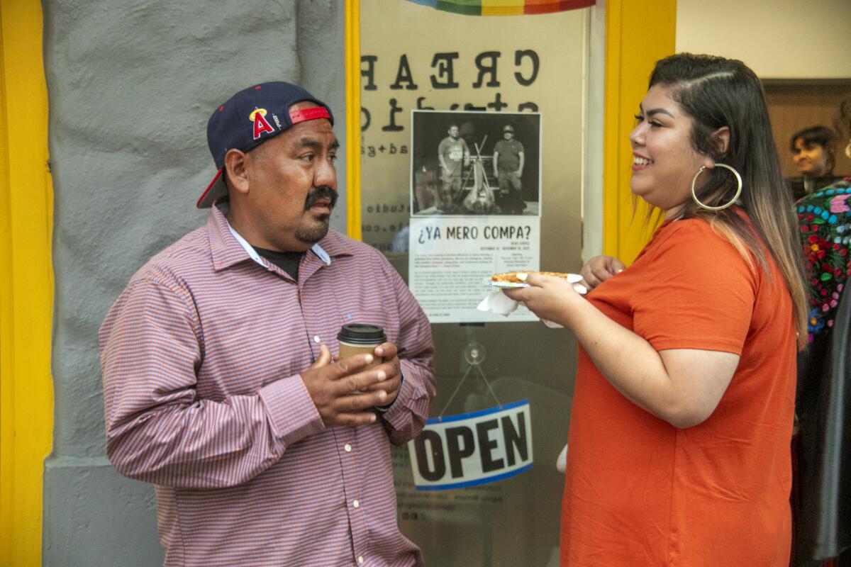 Outside Crear Studio on West 5th Street, artist Jesus Cortez talks with Karla Lawrence.