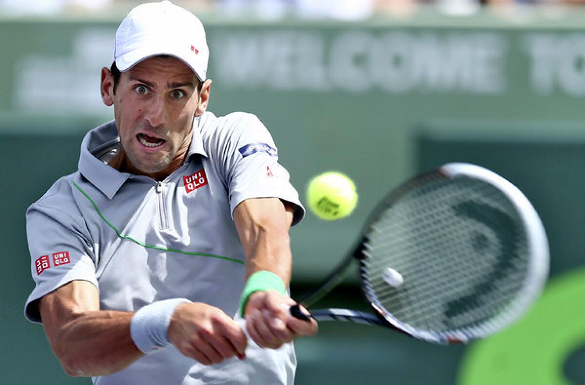 Novak Djokovic gets into a backhand return against Rafael Nadal in the Sony Open championship match on Sunday in Key Biscayne, Fla.