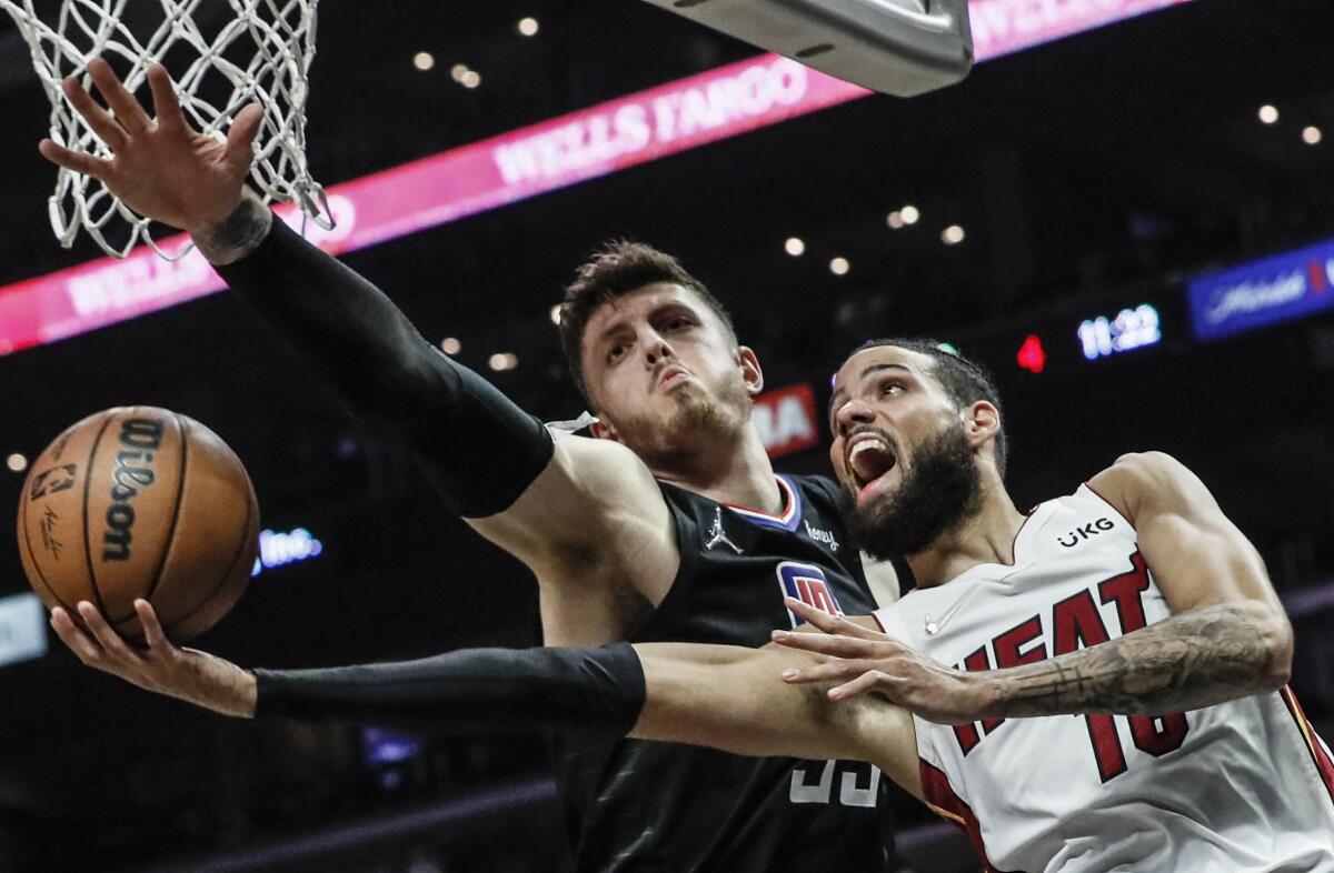 Clippers center Isaiah Hartenstein blocks the shot of Miami Heat forward Caleb Martin.