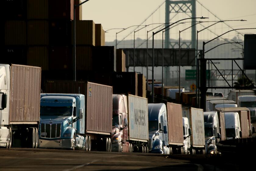 LONG BEACH, CALIF. - JUNE 2, 2023. Trucks sit along the side of the road in the Port of Los Angeles after Southern California dockworkers disrupted cargo activity Friday, June 2, 2023, at both local ports - major entry points for the country's imports - after contract talks deteriorated in recent days. (Luis Sinco / Los Angeles Times)