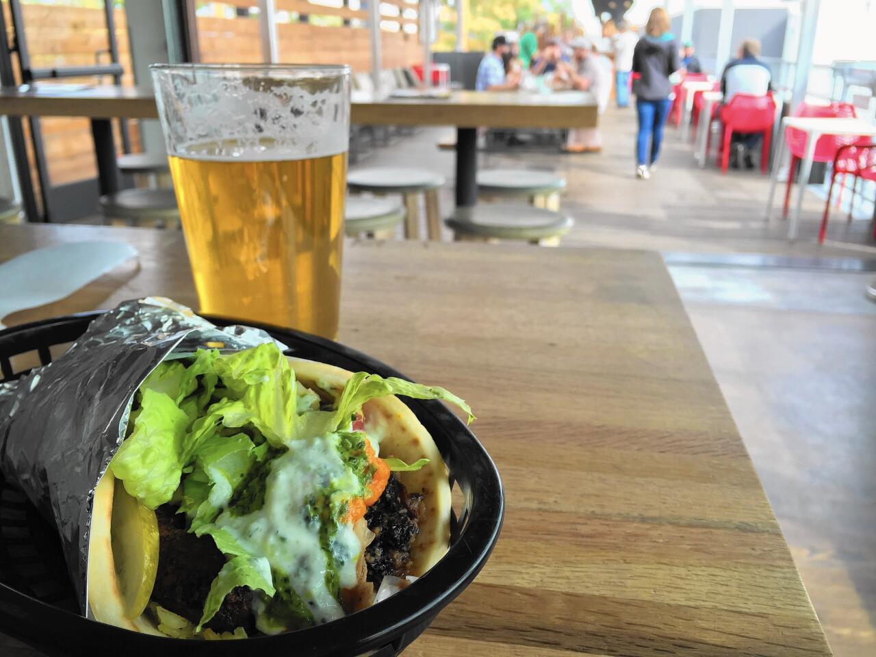 Beer and a chicken shawarma/falafel sandwich from Souk Shawarma at Avanti Food & Beverage in Denver.