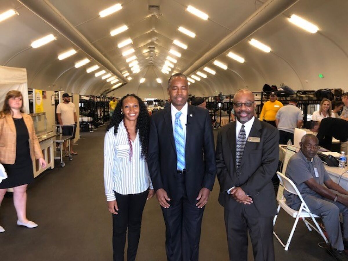 In this file photo from last year, Veterans Village of San Diego Homeless Shelter Director Lakesha Jones, U.S. Department of Housing and Urban Development Ben Carson and VVSD Executive Vice President Andre Simpson (left to right) are shown inside a bridge shelter tent that Veterans Village since has closed. The tent has been donated to the city of Chula Vista.