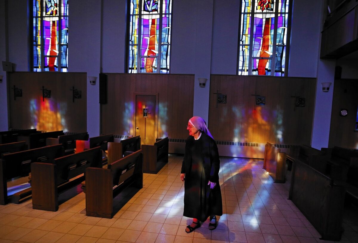 Mother Patricia Mary walks in the chapel at the Mullen Home for the Aged, run by Little Sisters of the Poor, in Denver, Colo. Nuns have a substantially higher risk of reproductive cancers than women who have children.