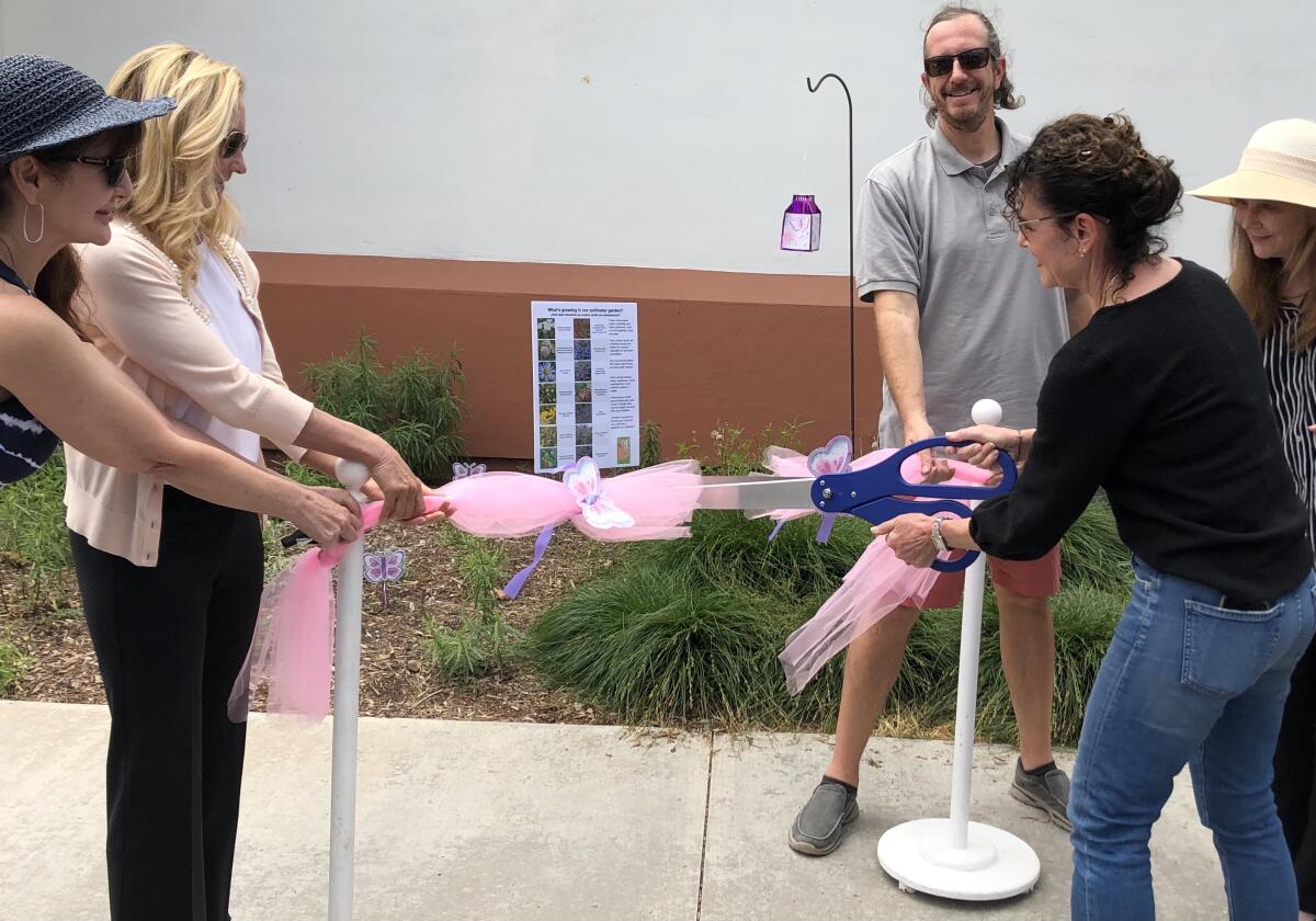 Solana Beach Mayor Lesa Heebner and council members cut the ribbon to commemorate the new pollinator garden.