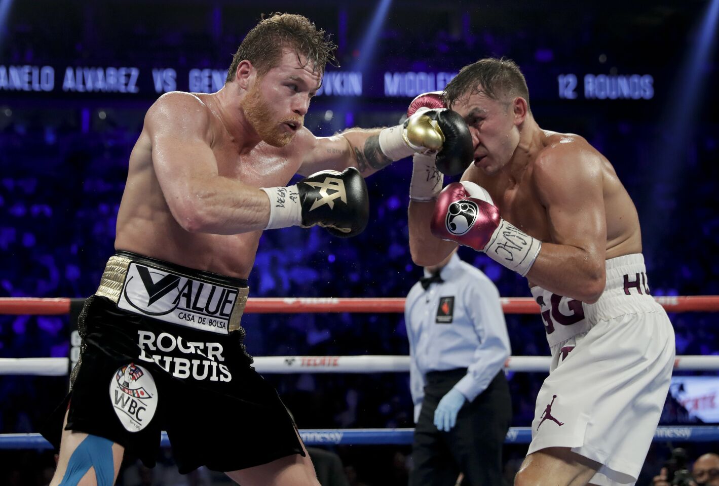 Canelo Alvarez, left, and Gennady Golovkin trade punches in the sixth round during a middleweight title boxing match, Saturday, Sept. 15, 2018, in Las Vegas.