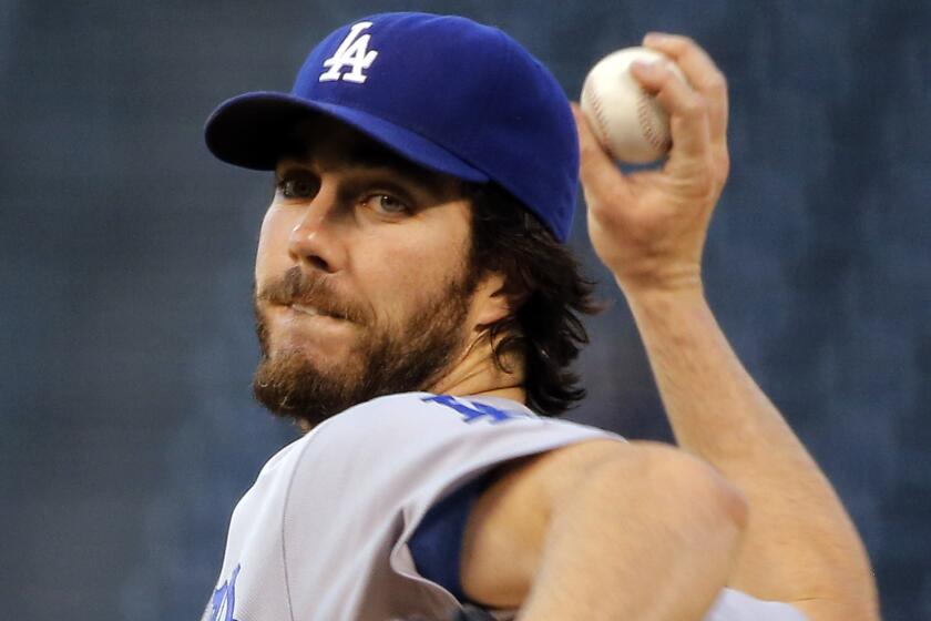 Dodgers starter Dan Haren delivers a pitch during the first inning of a 10-4 loss to the Colorado Rockies on Tuesday.