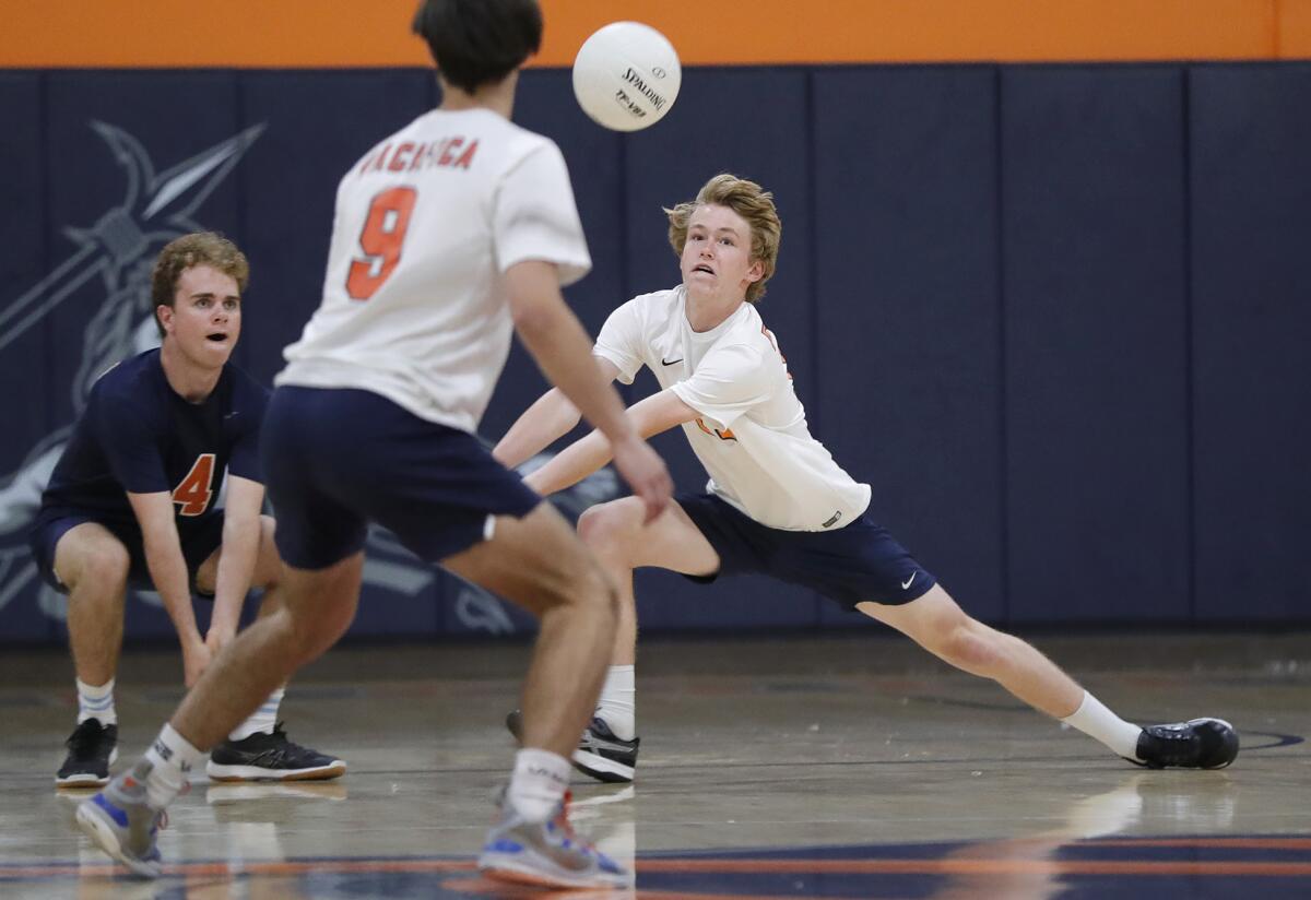 Pacifica Christian's Will Carlson, right, digs a ball as teammate Dan DeMars backs him during a CIF Division 4 quarterfinal.