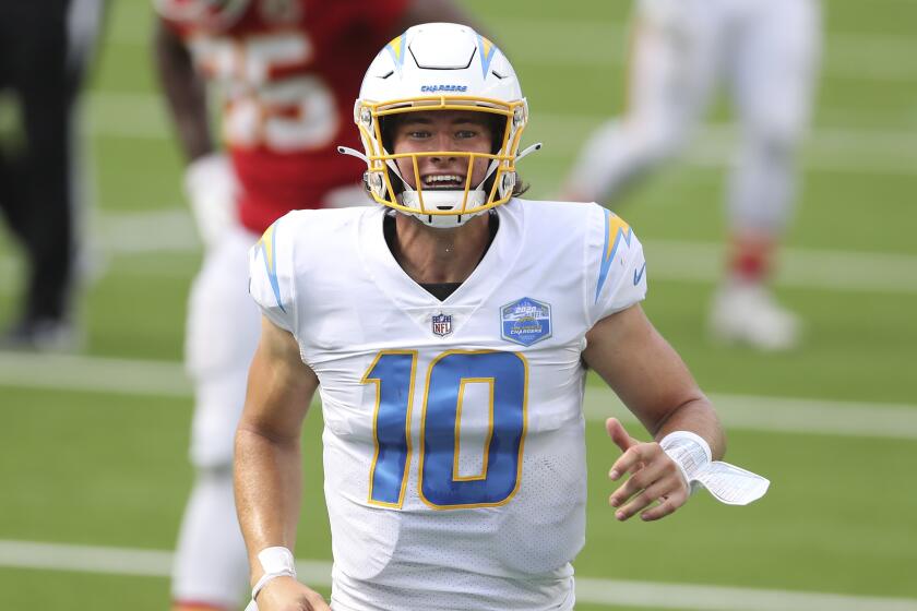 Los Angeles Chargers quarterback Justin Herbert (10) celebrates after his first career NFL touchdown pass.