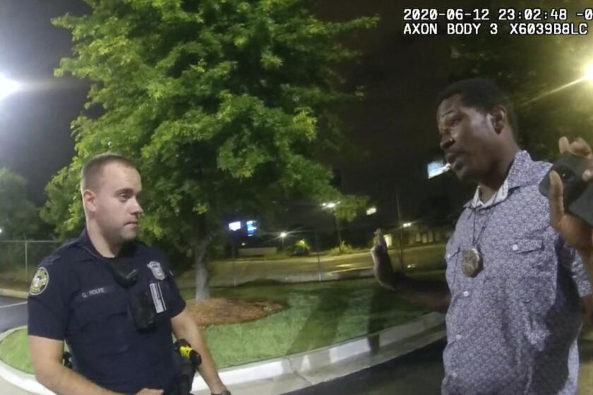 Officer Garrett Rolfe and Rayshard Brooks in an image taken from police body cam video.