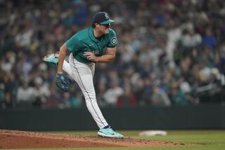 Seattle Mariners starting pitcher Robbie Ray follows through after giving up a single to catcher Max Stassi.