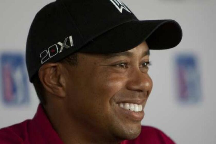 Tiger Woods answers questions at a press conference in Los Angeles last year.