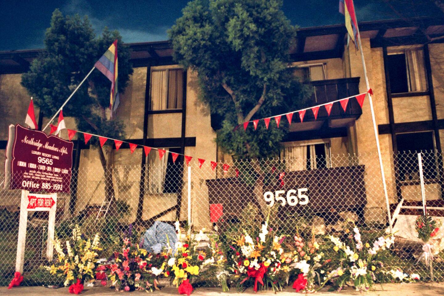 Flowers line a fence at the Northridge Meadows apartment complex a week after the quake.