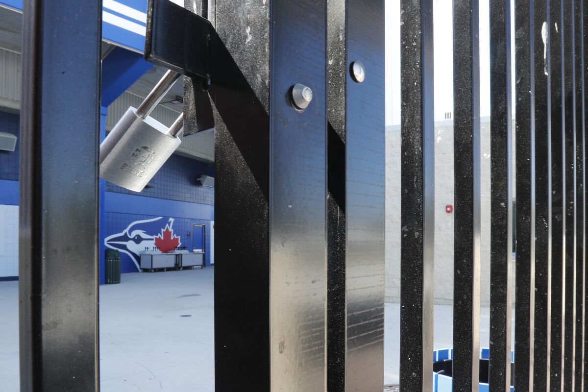 Gates to TD Ballpark, spring training home of the Toronto Blue Jays, are locked March 13 in Dunedin, Fla.