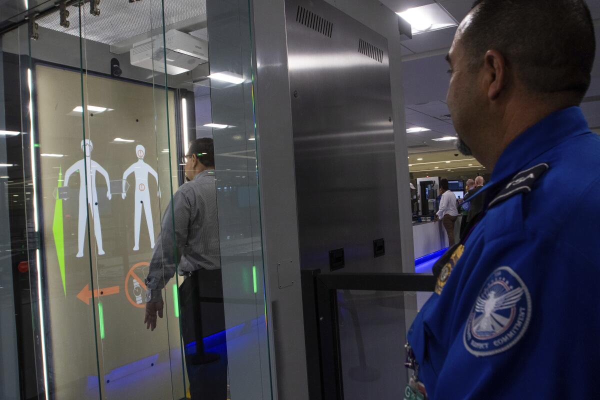 TSA officials demonstrating new screening equipment
