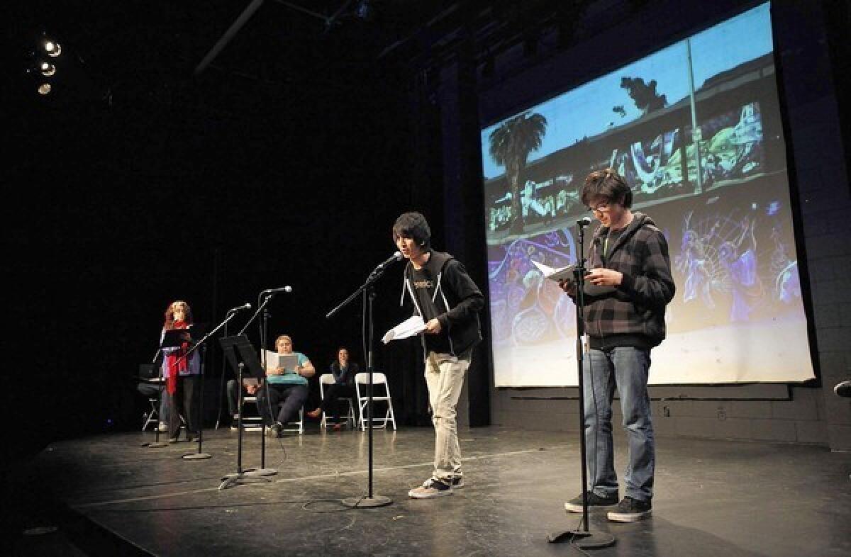 Monterey Continuation High School students Christopher Lizarraras, center, and Jose Herrera, right, participate in a play about the East Los Streetscapers -- muralists Wayne Healy and David Botello -- during a performance at the Plaza de la Raza's Margo Albert Theater.