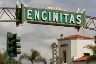 Not to be outdone by signs down south, the Encinitas sign shines above South Coast Highway 101 near the historic La Paloma Theater.