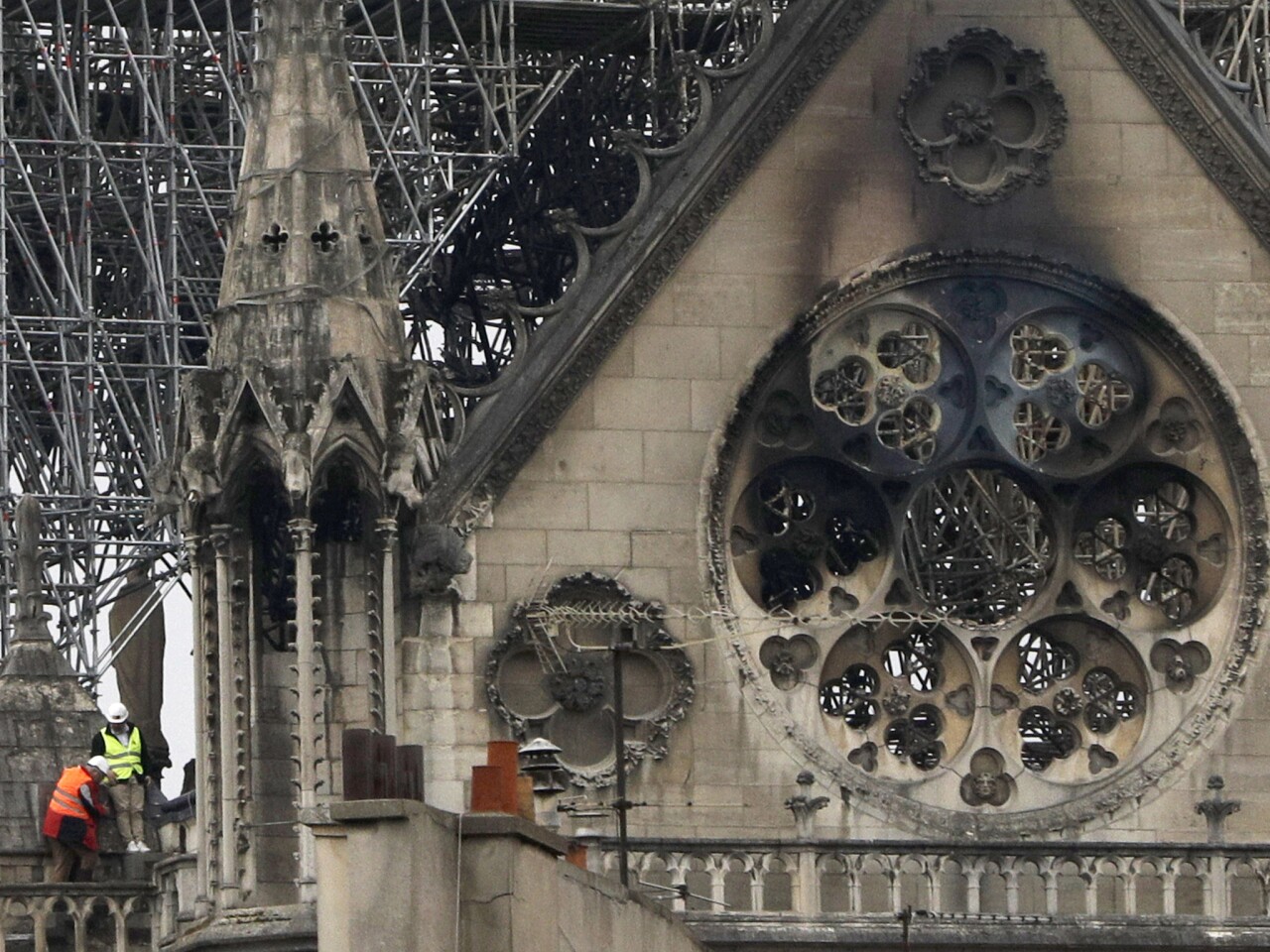 Experts inspect the damaged Notre Dame cathedral after the fire in Paris.
