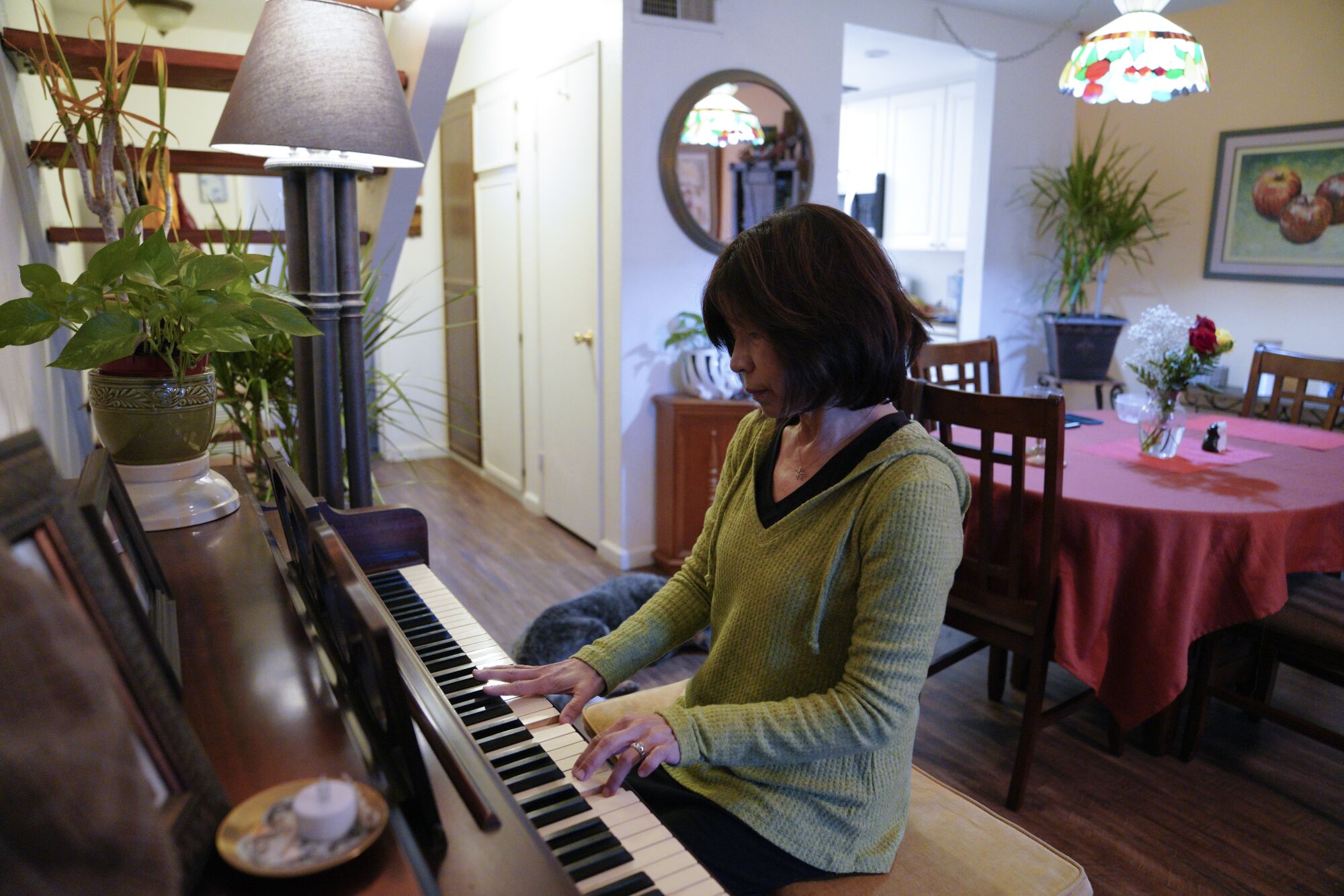 At her home in Santee, Carmen Kcomt plays the piano