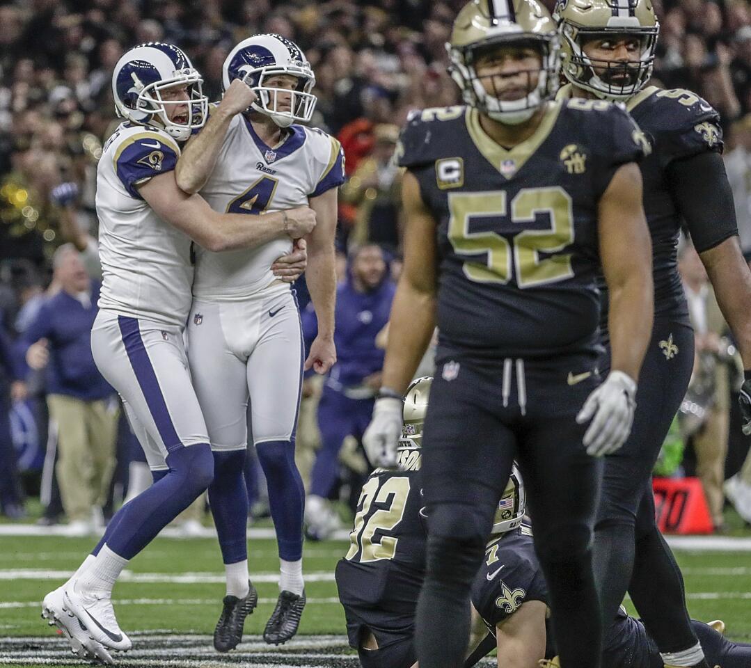 Rams kicker Greg Zuerlein is lifted by teammate Johnny Hekker after hitting a 57-yard field goal in overtime to beat the New Orleans Saints 26-23 in the NFC Championship at the Superdome.