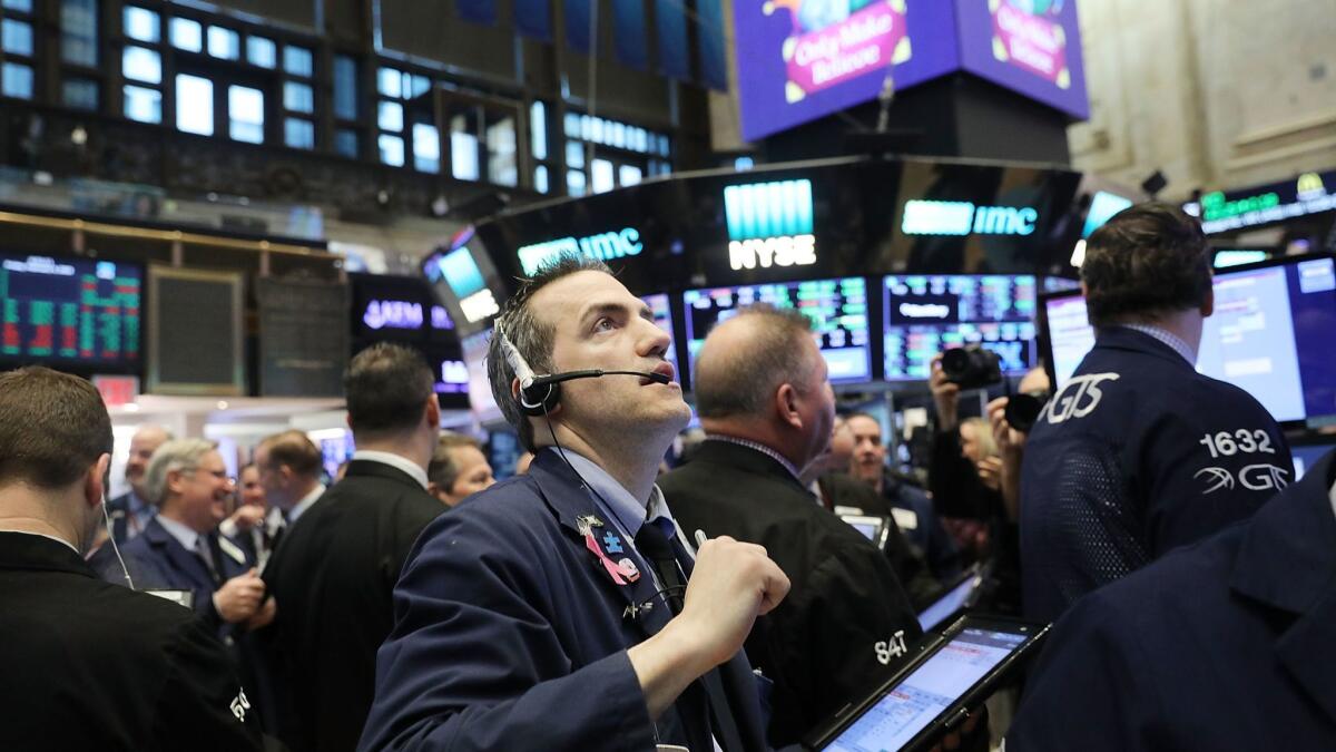 Traders work on the floor of the New York Stock Exchange on Friday.