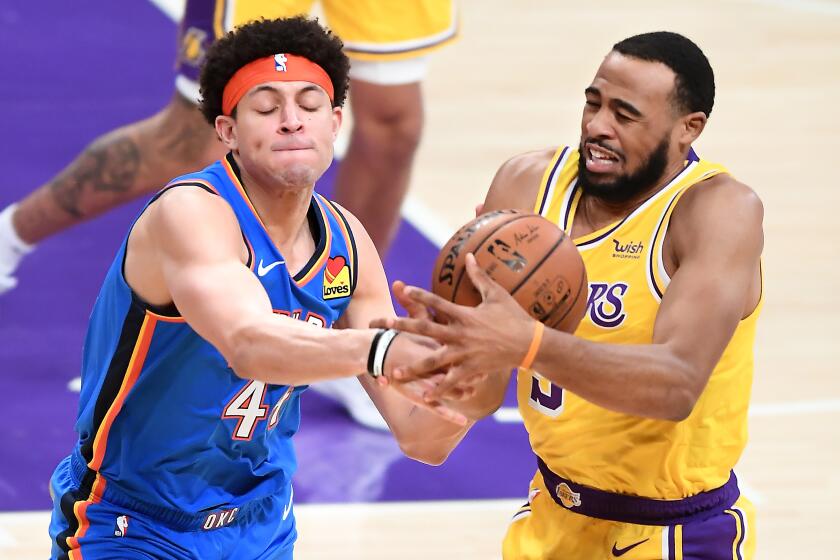 Lakers guard Talen Horton-Tucker and Thunder forward Justin Jackson battle for a loose ball on Monday at Staples Center