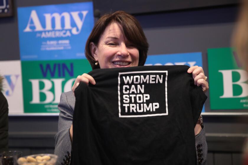 CLARION, IOWA - NOVEMBER 26: Democratic presidential candidate Sen. Amy Klobuchar (D-MN) holds up a shirt hnded to her by a guest during a campaign stop at Timbukbru brew pub on November 26, 2019 in Clarion, Iowa. The 2020 Iowa Democratic caucuses will take place on February 3, 2020, making it the first nominating contest for the Democratic Party in choosing their presidential candidate to face Donald Trump in the 2020 election. (Photo by Scott Olson/Getty Images)