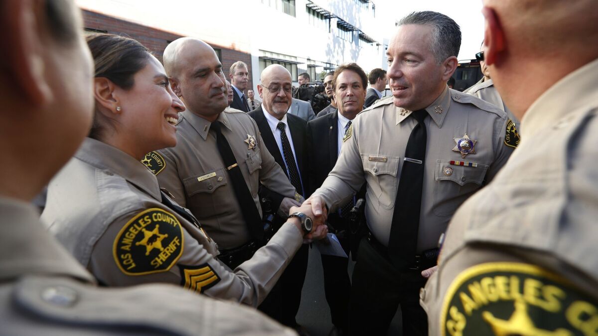 Alex Villanueva, the new Los Angeles County Sheriff, greets members of the force after his swearing-in ceremony in Monterey Park, Calif. on Dec. 3.