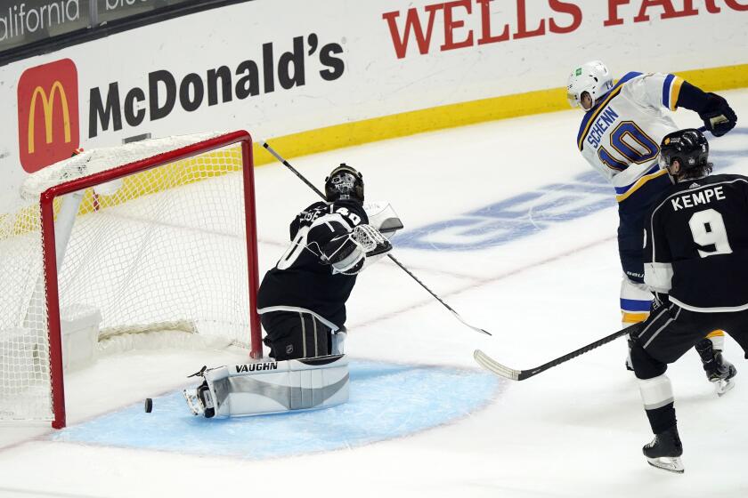 Kings goalie Cal Petersen gives up the winning goal to the Blues' Mike Hoffman, not shown, in overtime March 5, 2021.